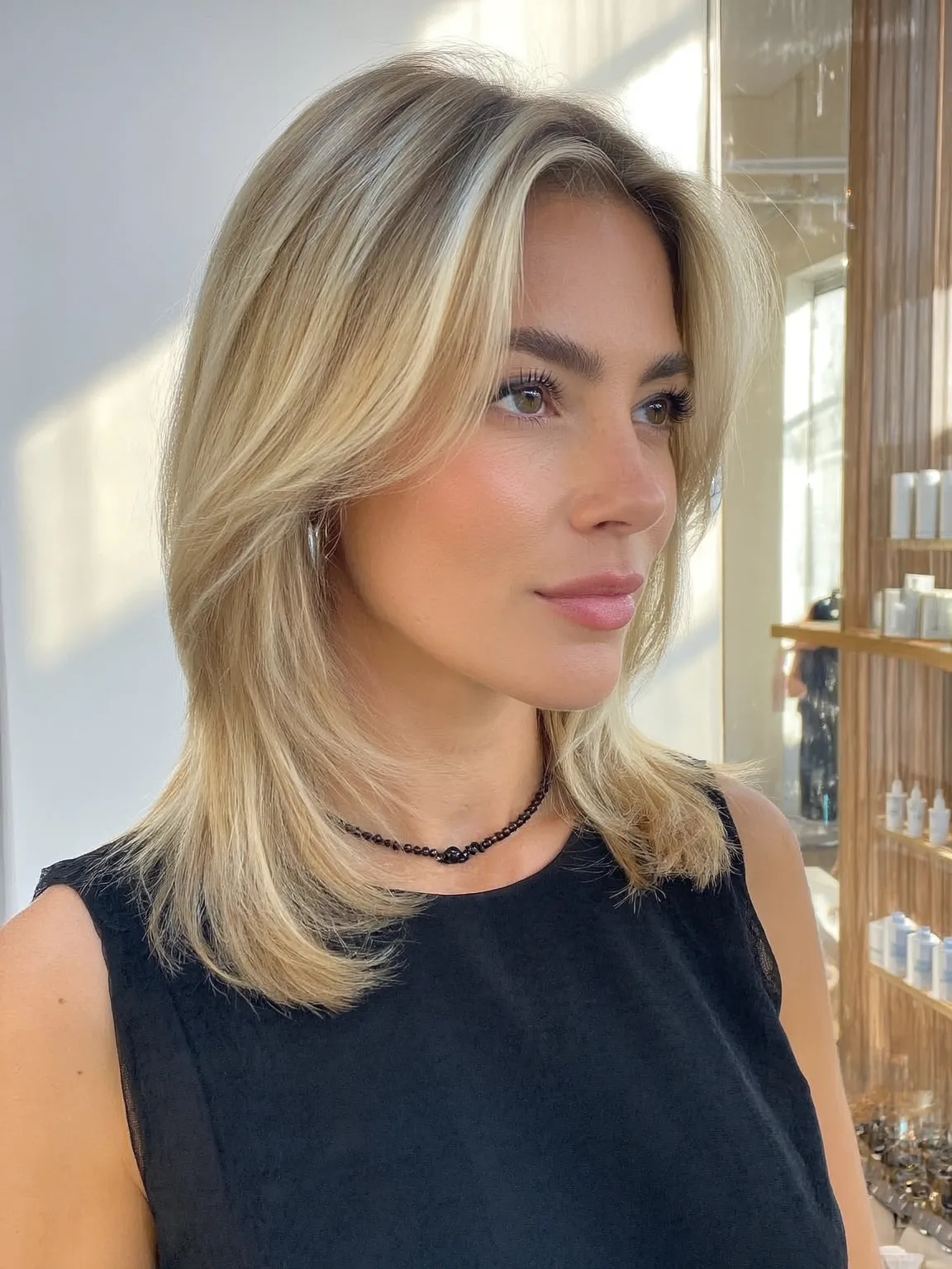Soft Sandy Blonde Long Layers with Curtain Bangs